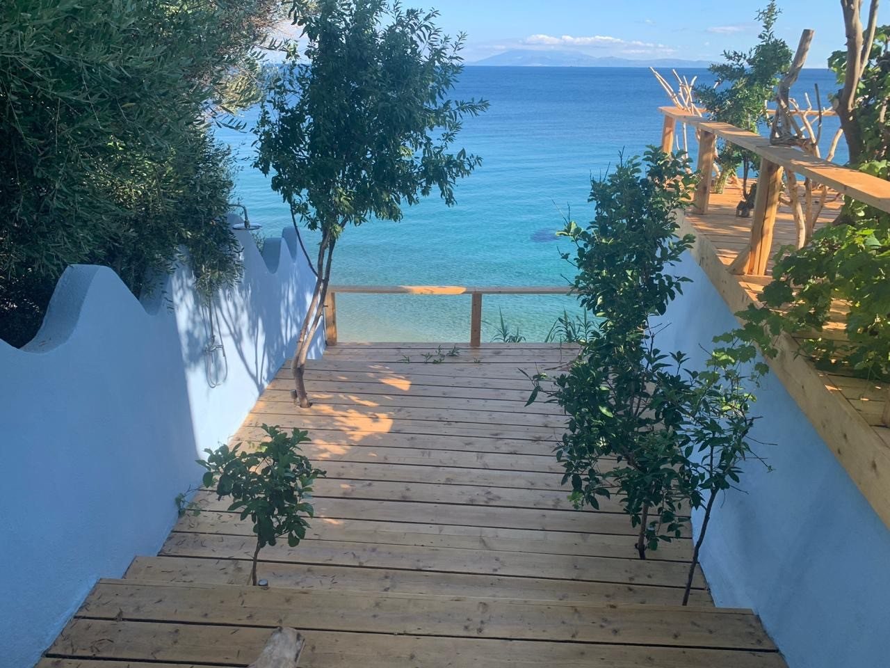 Steps leading down from the deck to the turquoise water