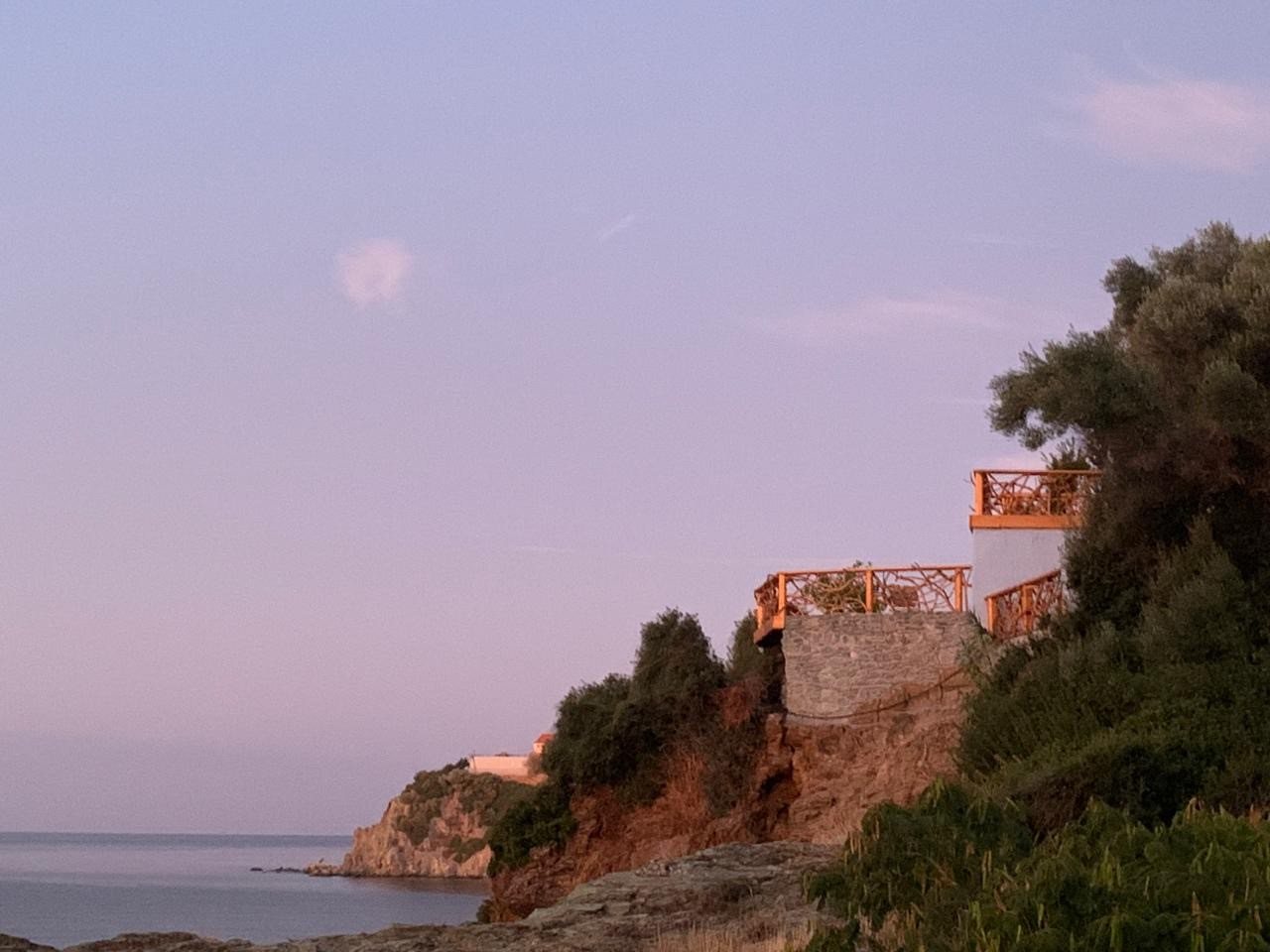 The Amodeli coast at dusk, the house on the shoreline above the sea