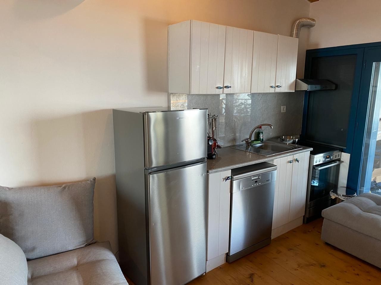 Kitchen with fridge, Miele dishwasher and stainless appliances