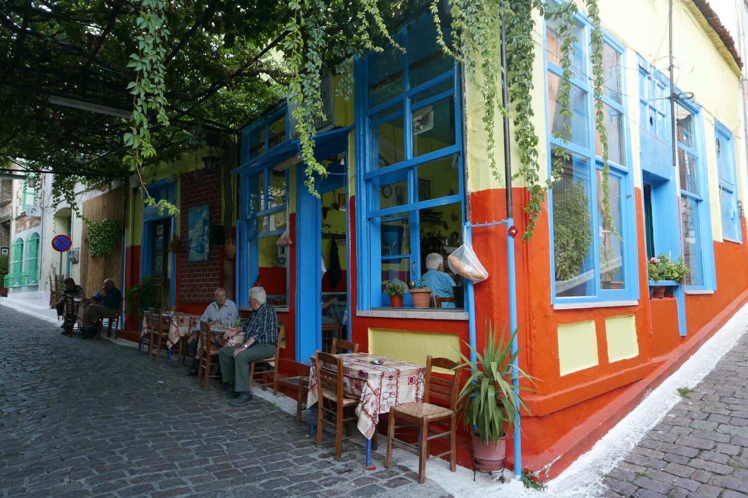 A colourful Plomari kafenio with elderly men sitting outside