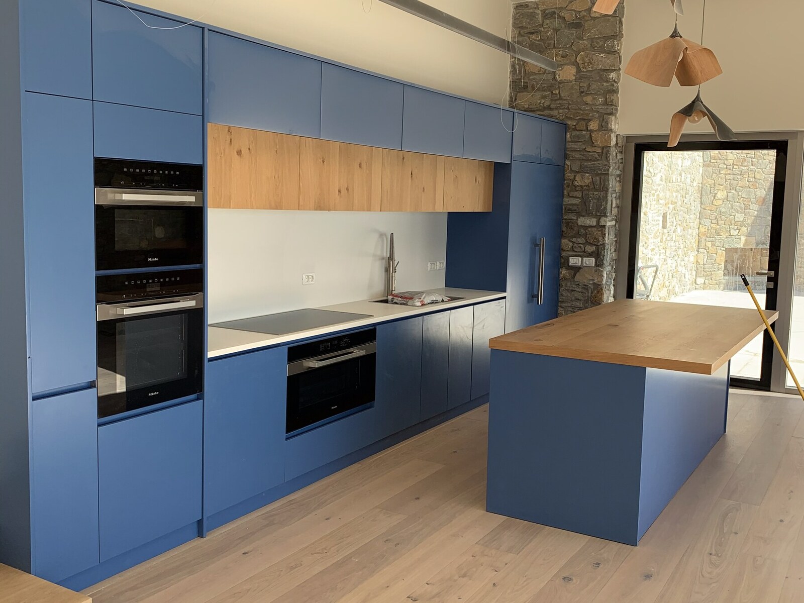 The blue Miele kitchen at Sunset Cliff Villa — wide view