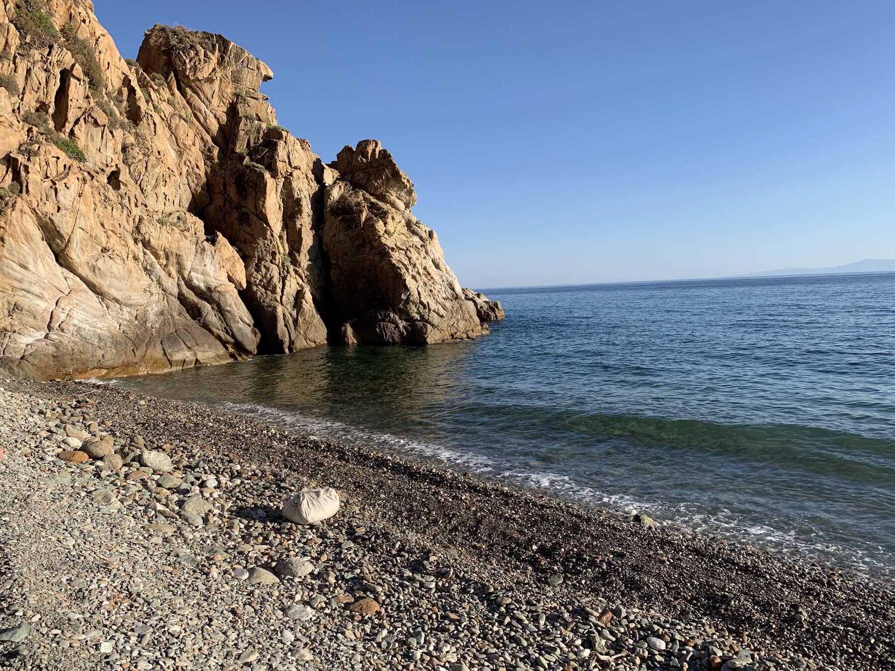 The private pebble cove below Sunset Cliff Villa