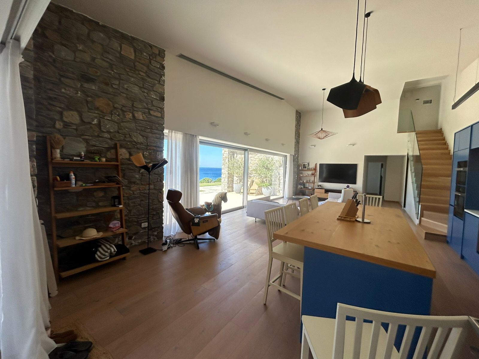 The deep-blue Miele kitchen with oak-topped island and bar seating