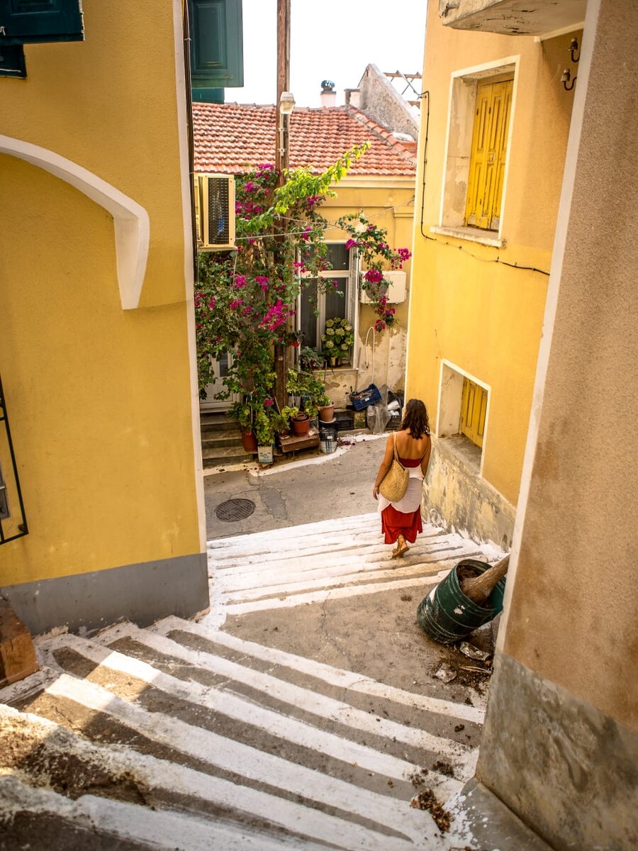 Whitewashed alley steps in Plomari, with bougainvillea